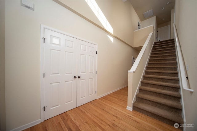 stairs with hardwood / wood-style flooring