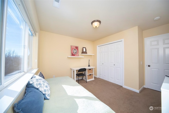 bedroom featuring dark colored carpet and a closet