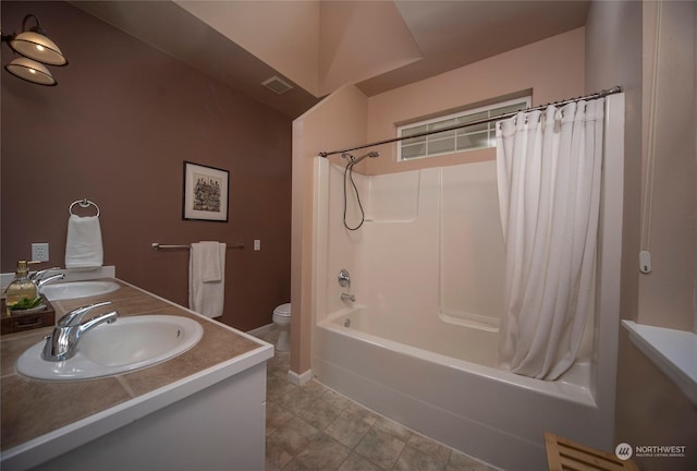 full bathroom with vanity, shower / tub combo with curtain, and toilet