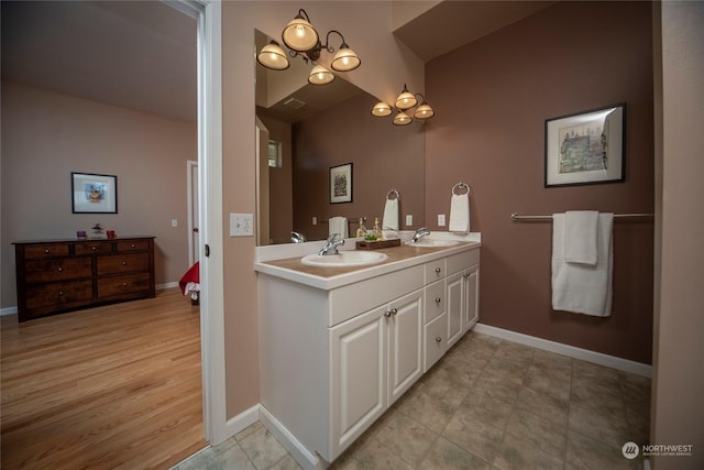 bathroom with vanity and a chandelier