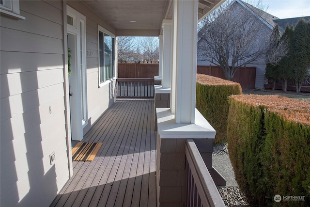 wooden terrace featuring covered porch