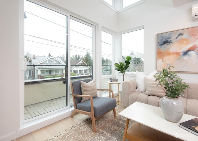 sunroom featuring an AC wall unit