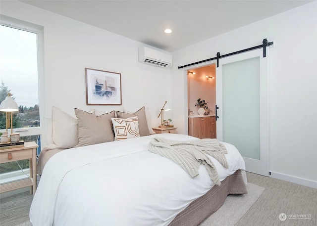 carpeted bedroom with a barn door and a wall mounted AC