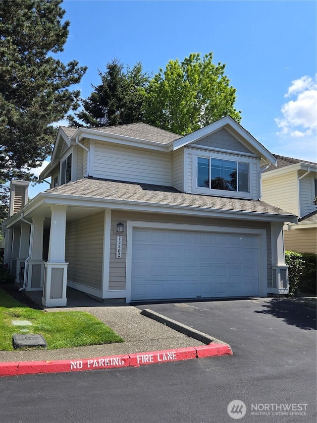 23302 54th Ave S Unit 2-1, Kent, WA 98032 - view of front of property with asphalt driveway, a chimney, an attached garage, and roof with shingles