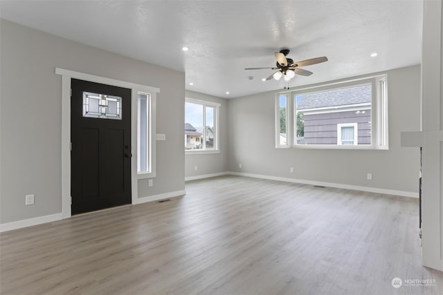 foyer entrance featuring visible vents, a ceiling fan, wood finished floors, recessed lighting, and baseboards