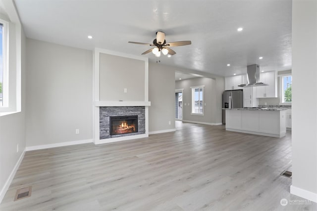 unfurnished living room featuring visible vents, baseboards, light wood-type flooring, recessed lighting, and a ceiling fan