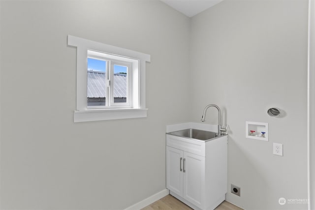 washroom featuring hookup for a washing machine, light wood-style floors, cabinet space, hookup for an electric dryer, and a sink