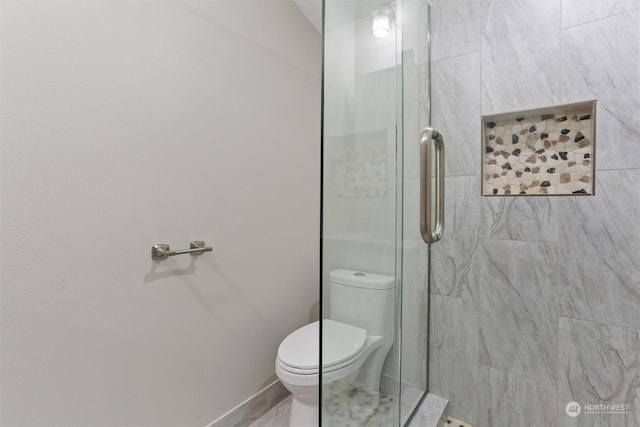 bathroom with toilet and a stall shower