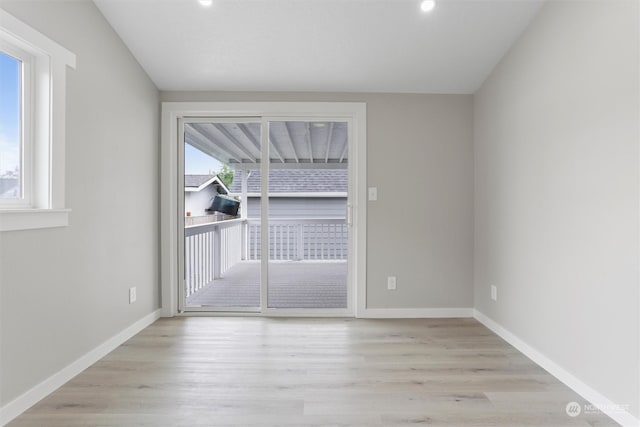 empty room featuring recessed lighting, wood finished floors, and baseboards