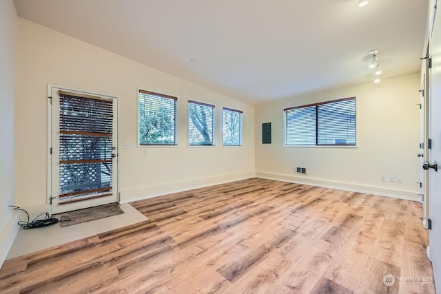 spare room with light wood-type flooring and electric panel