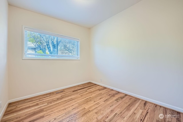 spare room with light hardwood / wood-style flooring