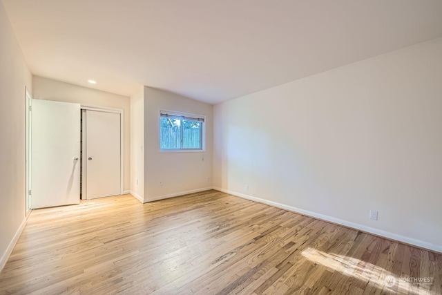 spare room with light hardwood / wood-style floors