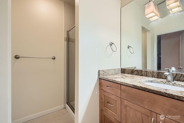 bathroom with tile patterned floors, vanity, and an enclosed shower