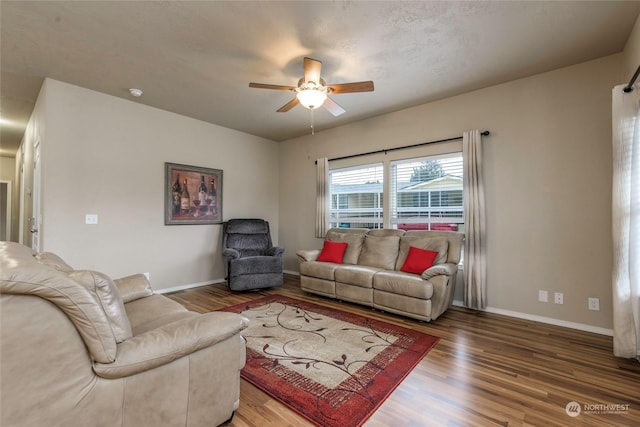 living room with ceiling fan and wood-type flooring