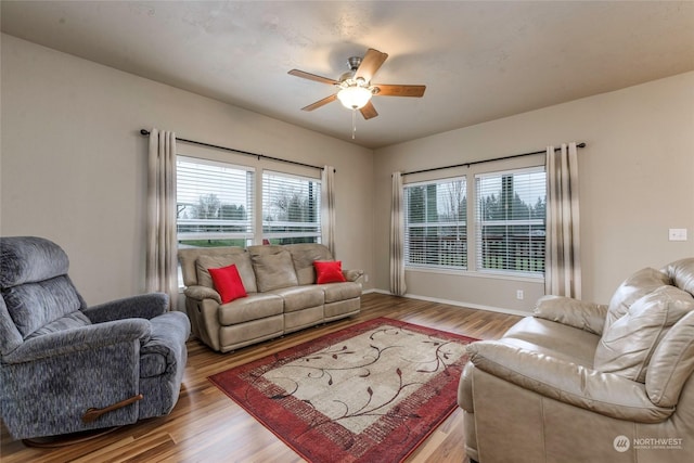 living room featuring light wood-type flooring and ceiling fan