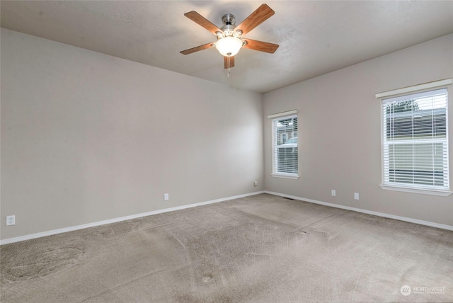 carpeted empty room with ceiling fan