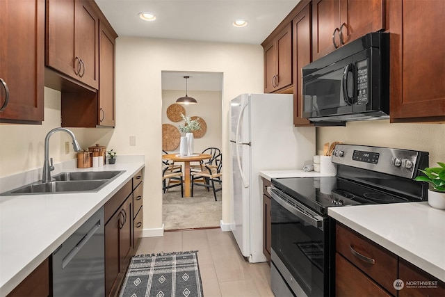 kitchen featuring sink, black appliances, and pendant lighting