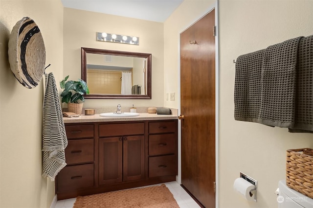 bathroom with vanity, toilet, and tile patterned floors