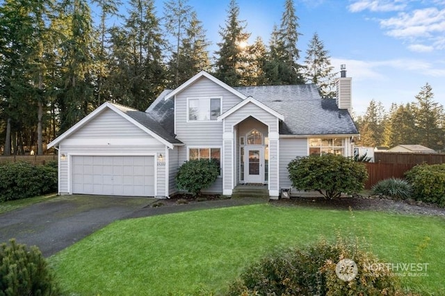 view of front of property featuring a garage and a front lawn