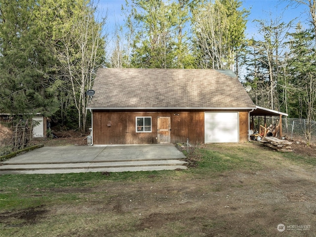 view of outdoor structure featuring a carport and a garage