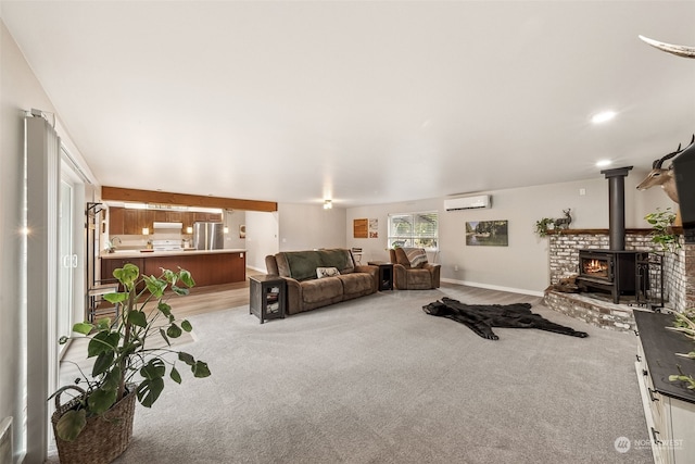 carpeted living room with a wood stove and a wall mounted air conditioner