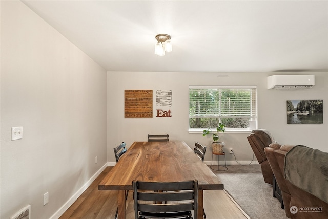 dining room featuring a wall mounted AC