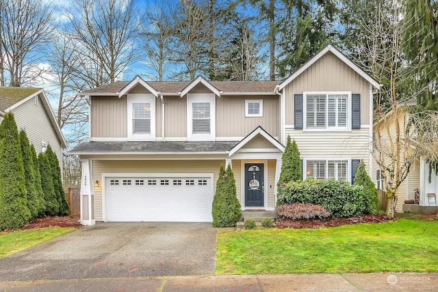 view of front of property with a garage and a front lawn