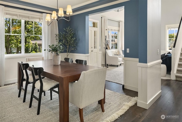 dining room with crown molding, dark hardwood / wood-style floors, and a chandelier