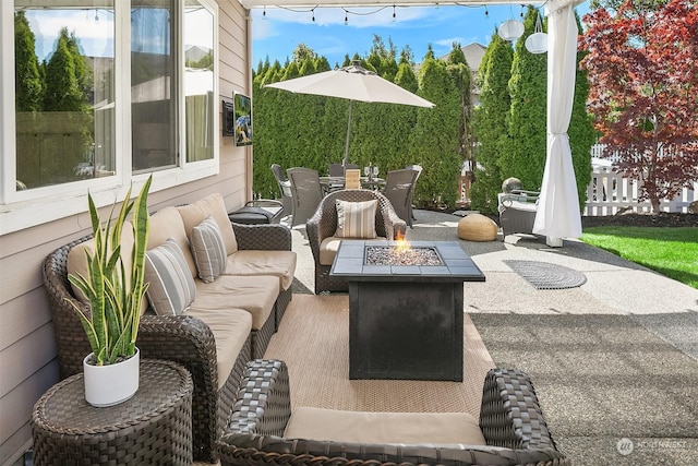 view of patio / terrace with an outdoor living space with a fire pit