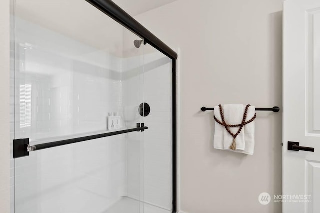 bathroom with a shower with shower door