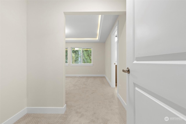 hall with light colored carpet