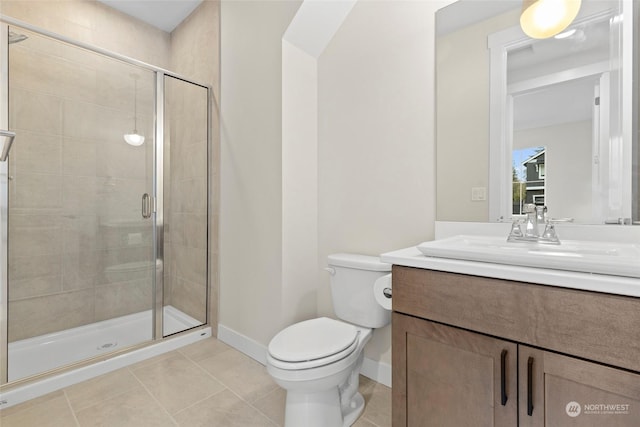 bathroom with tile patterned floors, toilet, a shower with door, and vanity