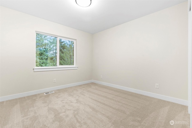 empty room featuring light colored carpet