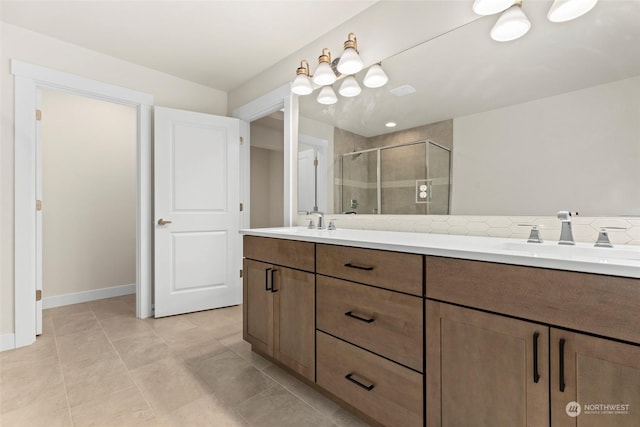 bathroom featuring a shower with shower door, vanity, and tile patterned flooring