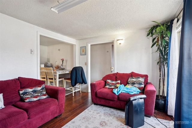 living room featuring hardwood / wood-style flooring and a textured ceiling