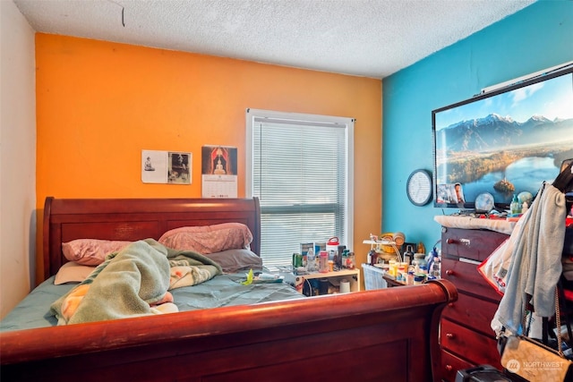 bedroom with multiple windows and a textured ceiling