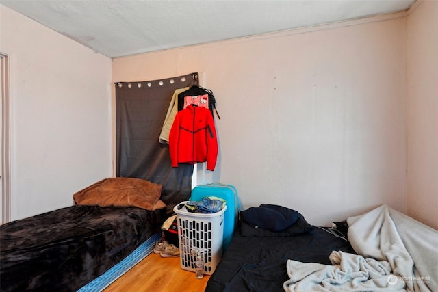 bedroom with hardwood / wood-style floors and a textured ceiling