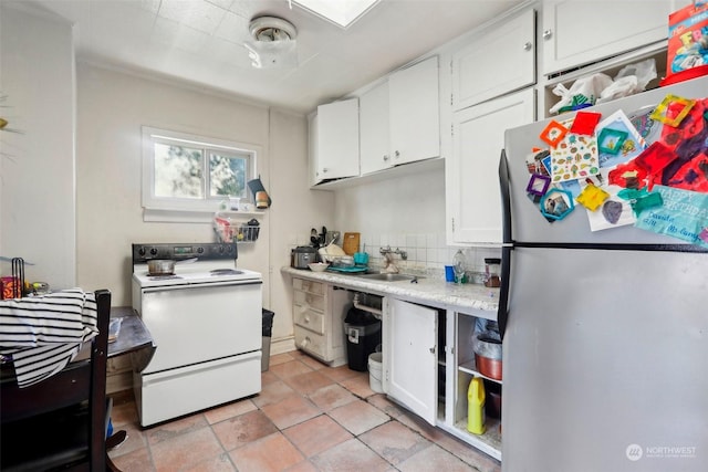 kitchen featuring sink, stainless steel fridge, white cabinets, and white range with electric stovetop