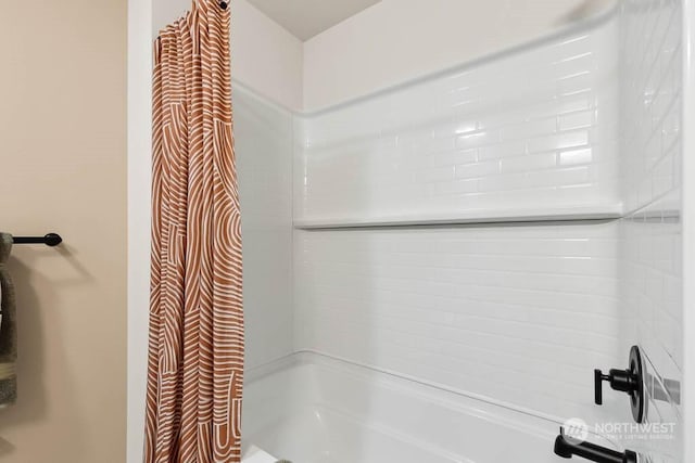 bathroom with shower / bath combination with curtain