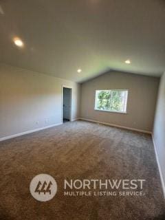 bonus room with vaulted ceiling and carpet flooring