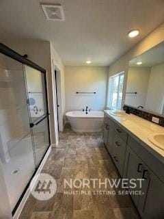 bathroom featuring vanity and shower with separate bathtub