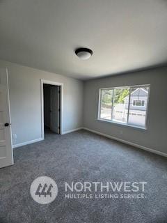 unfurnished bedroom featuring dark colored carpet