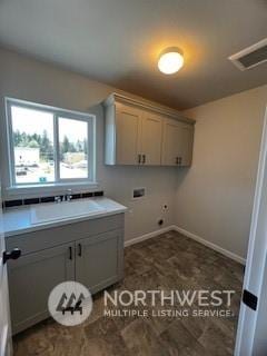 clothes washing area featuring cabinets and washer hookup