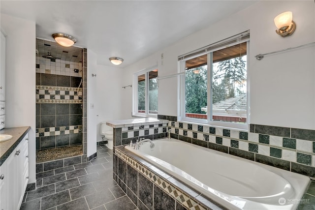 full bathroom featuring vanity, tile patterned floors, toilet, and separate shower and tub