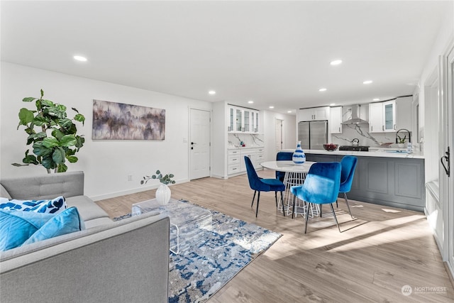 living room with sink and light hardwood / wood-style floors