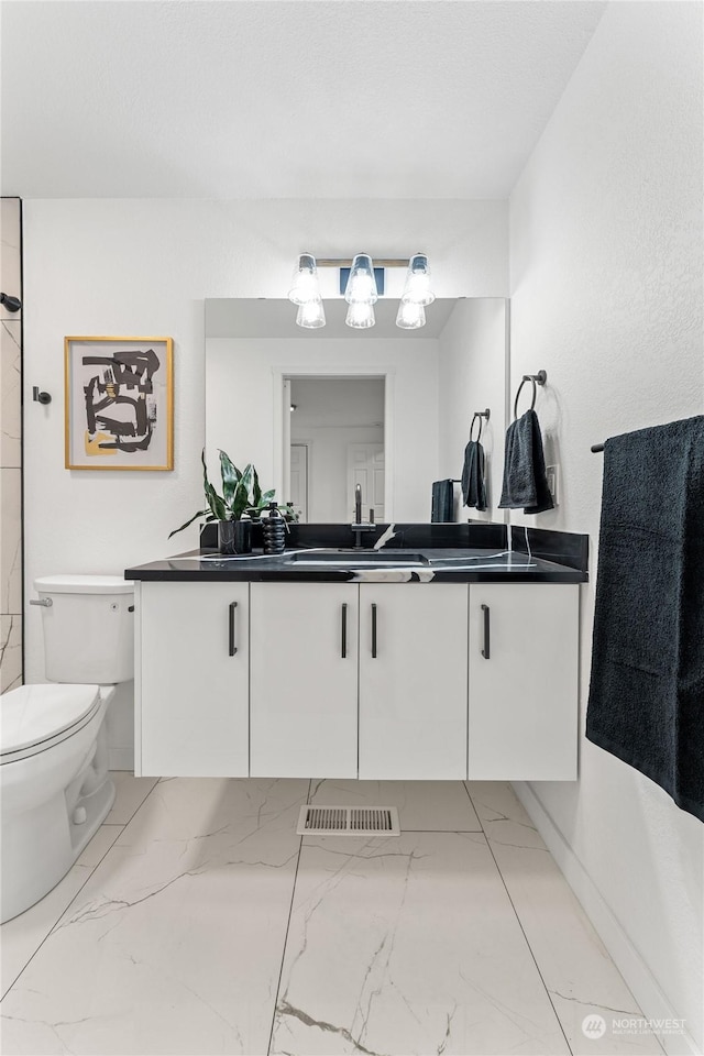 bathroom with vanity and toilet