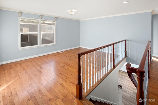 stairway featuring crown molding and wood-type flooring