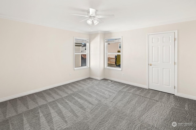 spare room with ceiling fan, carpet, and ornamental molding