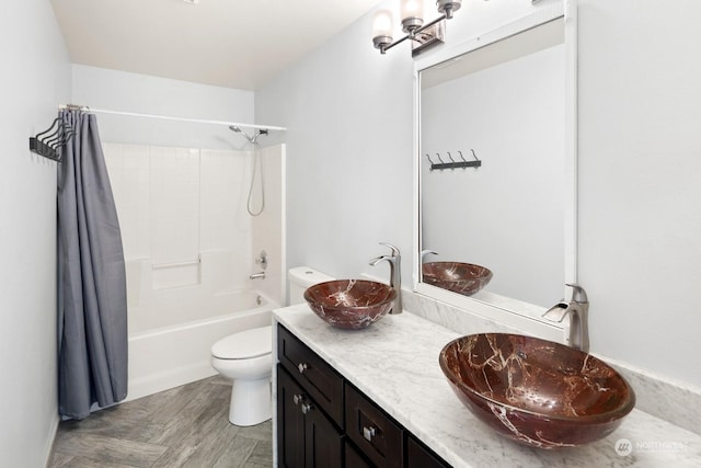 full bathroom with hardwood / wood-style flooring, toilet, shower / tub combo with curtain, and vanity