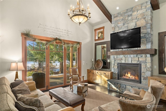 living room with beam ceiling, a healthy amount of sunlight, an inviting chandelier, and a stone fireplace